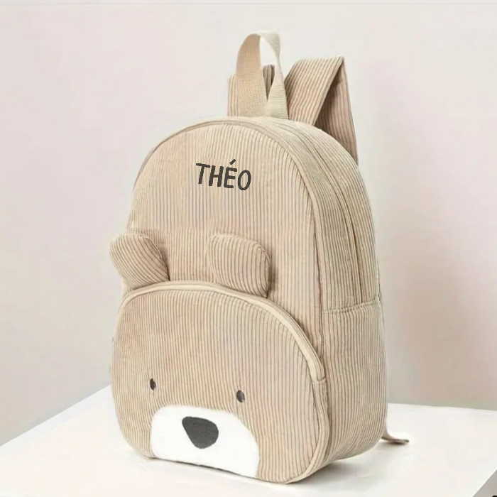 Sac à dos enfant personnalisé en velours marron, vue de côté sur un fond neutre.