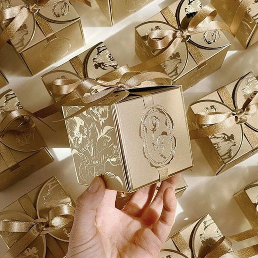Gold wedding favor boxes with ribbon